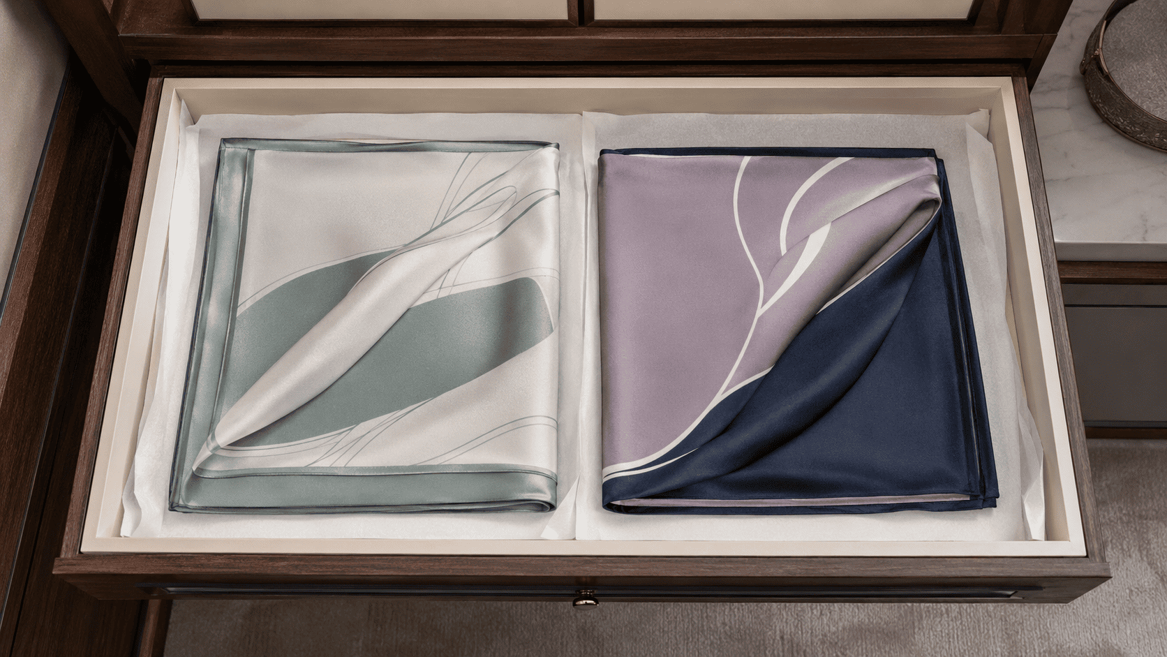 Square silk scarf drying flat on a clean white cotton towel